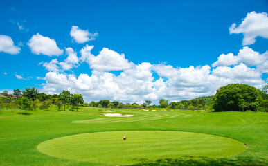 Beautiful green view at golf course ,green trees and mountain blue sky white cloud background