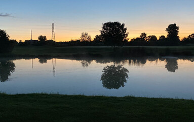 Naklejka na ściany i meble pre-sunrise golf course colorful sky tree cloud pond reflections power tower