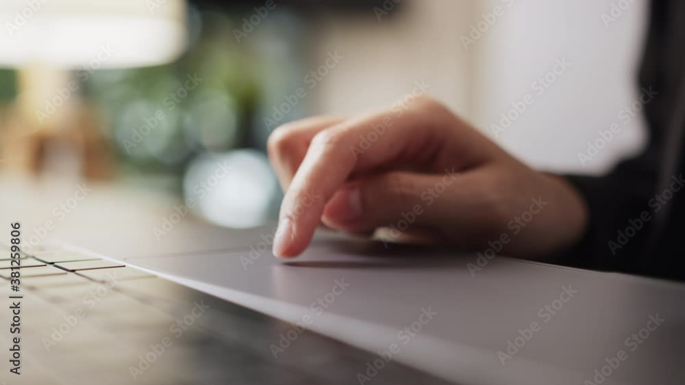 Poster close-up of hands using mouse on laptop and keyboard on the table.