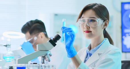 Asian scientist take test tube