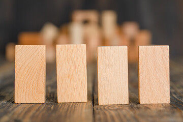 Business concept with wooden blocks on wooden background side view.