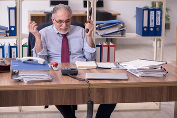 Old male employee unhappy with excessive work