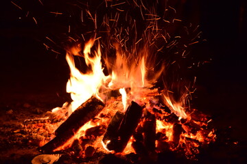 Fototapeta na wymiar A bonfire in the open on a warm summer evening