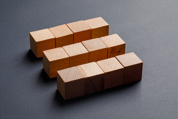 Business concept with wooden cubes on dark grey background high angle view.