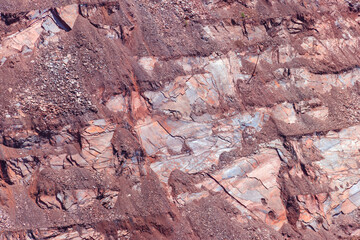 Close-up of red mining levels at iron ore quarry. Open-cast mine, open pit. Background, texture
