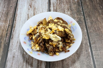 Fried and stirred noodle with chicken egg on the plate. Famous traditional side dish noodle menu in Asia restaurant. 