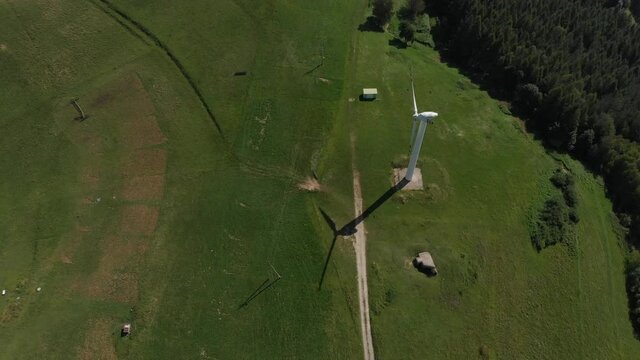 Flying over wind turbine in mountains