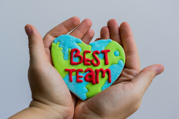 Female hands holding a heart shape cookie with 