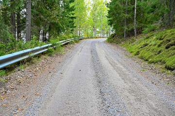 Fototapeta premium gravel road with railing trough Swedish forest