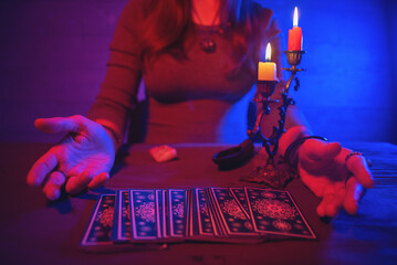 Fortune teller is reading a future by tarot cards.