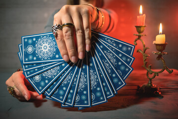 Fortune teller is reading a future by tarot cards.