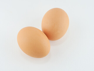 2 eggs, fresh and clean brown shell, placed on a white background