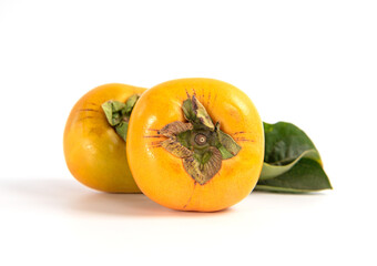 Fresh ripe persimmon with leaves isolated on white background. Healthy food concept