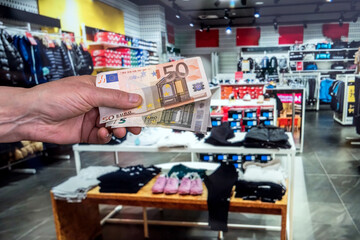 sale concept. man give euro bills in shop