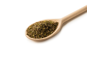 Oregano spice in wooden spoon isolated.