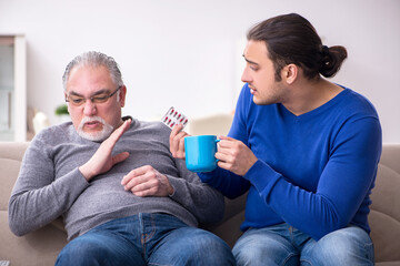 Young man looking after his sick father
