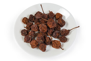 Dried pears on the white dish on a white background