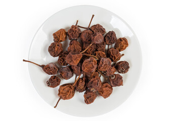 Top view of dried pears on dish on white background