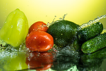 set of vegetables for salad with water splashes on gradient background