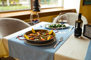 Spanish dishes seafood paella and padron peppers