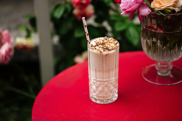 Side view on chocolate milkshake with a straw