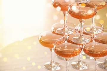 Tower made of glasses with champagne on table © Pixel-Shot