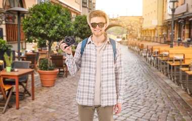 Young tourist with photo camera in old city
