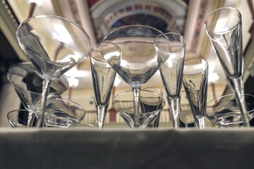 Various empty glasses on the table with blurred luxury interior, selective focus