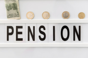 Board with word PENSION and money, closeup