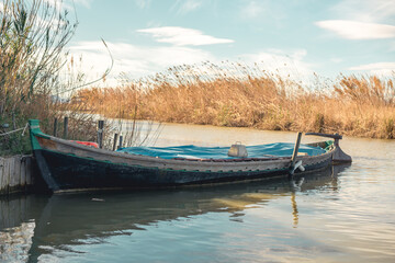 a small boat parked on the river
