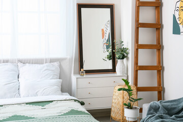 Interior of modern stylish bedroom with mirror