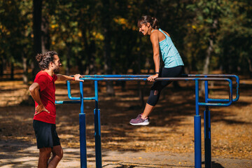 Fototapeta premium Exercising on parallel bar in the park
