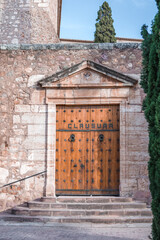 large front door between the trees to the monastery in the mountains