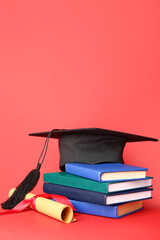 Graduation hat, diploma and books on color background