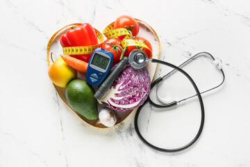 Vegetables, stethoscope, measuring tape, lancet pen and glucometer on white background. Diabetes...