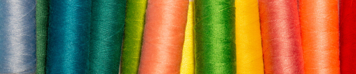 Close up looking of several color thread reels.