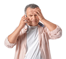 Stressed mature man talking by phone on white background