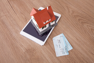 Home model and two train tickets on ticket