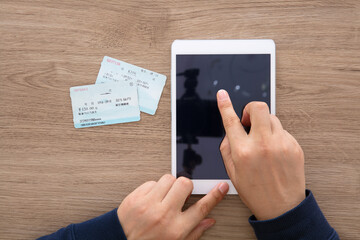 Use your hand to operate the tablet computer and grab the train ticket home