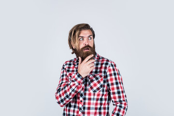 Fototapeta premium male beauty concept. Portrait of bearded hipster. guy with long lush beard and mustache on face. handsome confident man has perfect hairstyle. surprised bearded man in checkered shirt