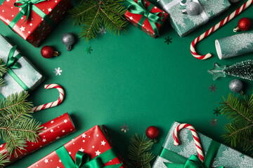 Different Christmas accessories on green background, top view