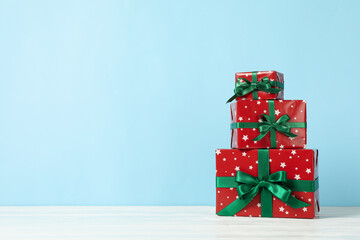 Christmas boxes on blue background, space for text