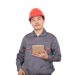 Migrant worker wearing red hard hat holding tablet computer in front of white background