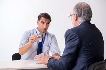 Old businessman meeting with advocate in pre-trial detention