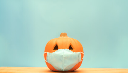 October break pumpkin.Halloween facial mask as a jack o lantern pumpkin wearing a medical face mask...