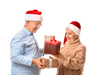 Elderly couple with Christmas gifts on white background