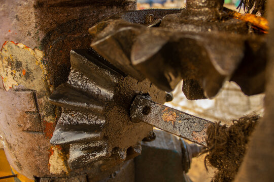 Close up of oily and greasy mechanical gears in a machine