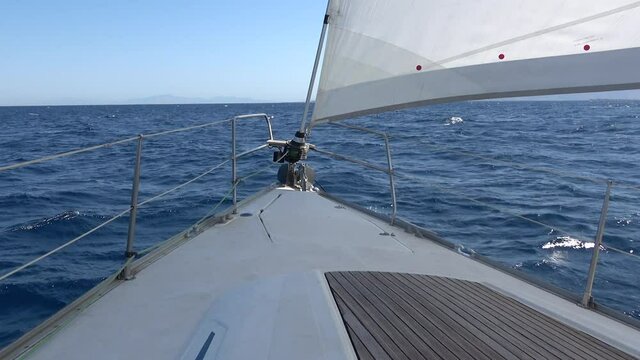 View of the sea from the bow of a sailboat that travels with nice weather.