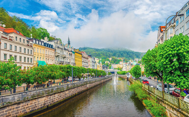 Karlovy Vary historical city centre with Tepla river pedestrian embankment, colorful beautiful...