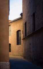 Narrow street of Siena in Tuscany, Italy, in the morning light